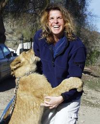 Dr. Jennifer Conrad with a lion cub
